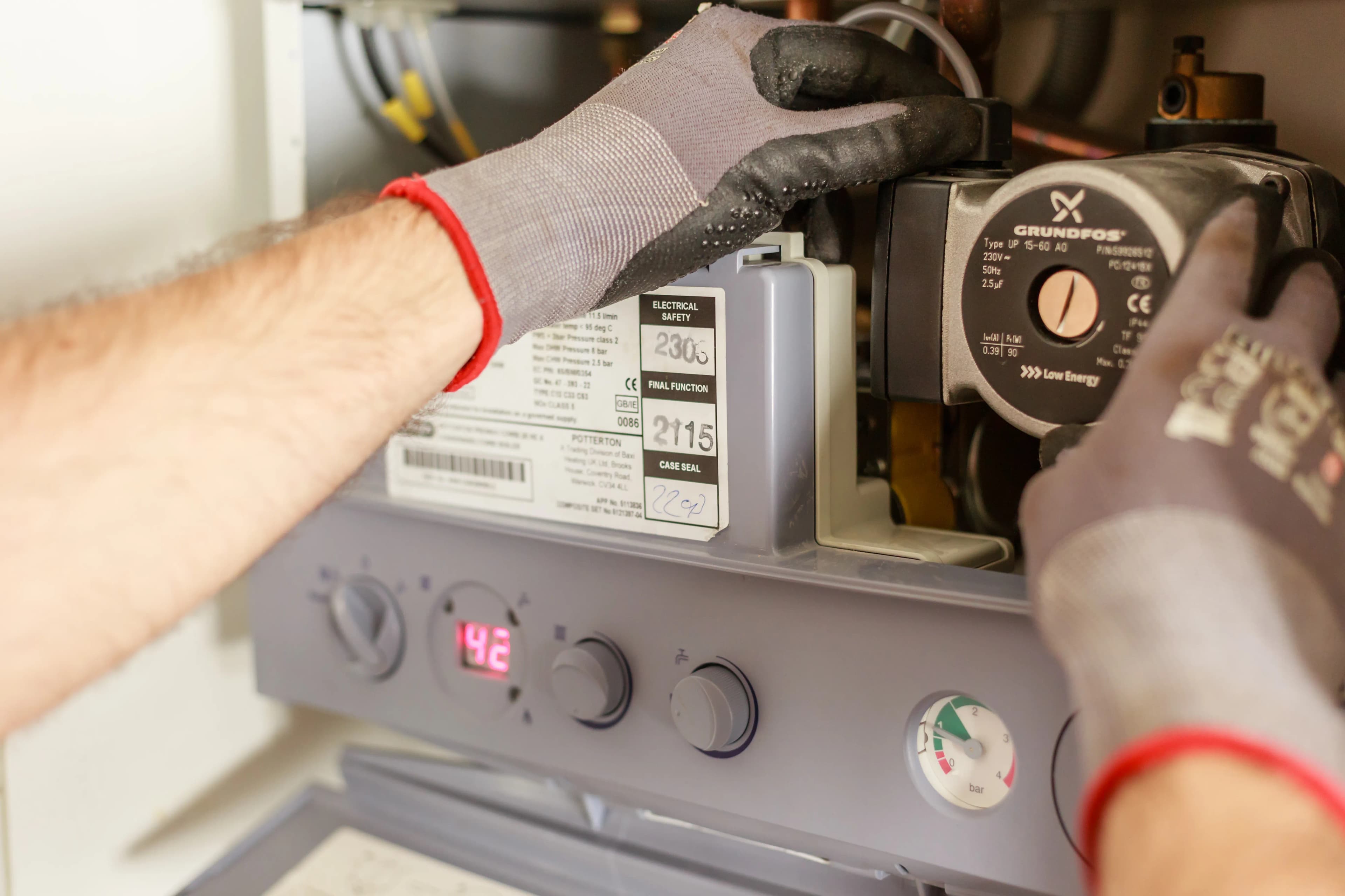Engineer servicing a domestic gas boiler